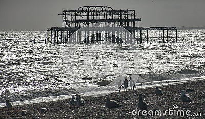 The old pier in Brighton and the beach. Stock Photo