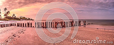 Old pier in the ocean at Port Royal Beach at sunrise Stock Photo