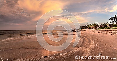 Old pier in the ocean at Port Royal Beach at sunrise Stock Photo