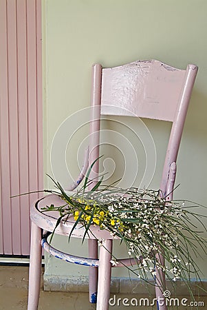 Old pink chair and flowers Stock Photo