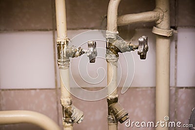 Old pipes with faucet valves and filters. Stock Photo