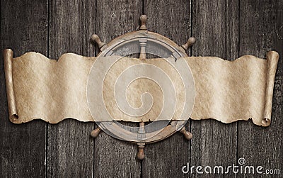 Old pirates map scroll and steering-wheel over wood background. Mixed media. Stock Photo