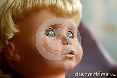 Old plastic doll with blonde hair. Stock Photo