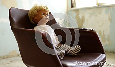 Old plastic doll with blonde hair. Stock Photo