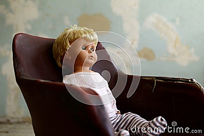 Old plastic doll with blonde hair. Stock Photo