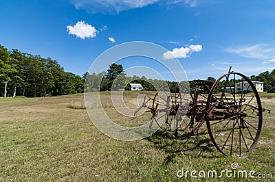 Old plough on a farm landscape in Maine, USA Stock Photo