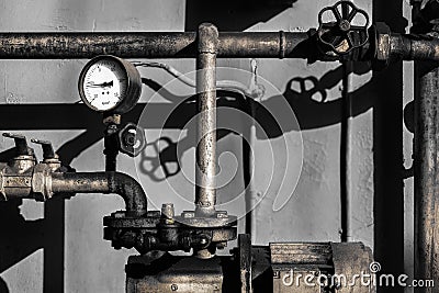 Old plumber pipes with a bar meter Stock Photo