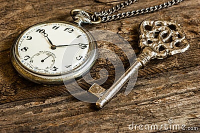 Old pocket watch and chain, vintage locket watch with retro key Stock Photo