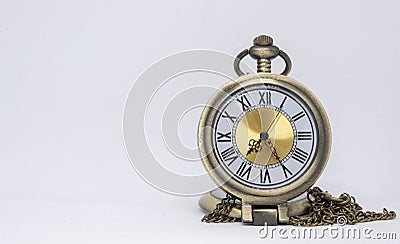 The old pocket watch is a necklace located on the white floor being separated Stock Photo