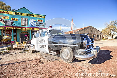 Old police car in front of historic Sundries Building. Editorial Stock Photo