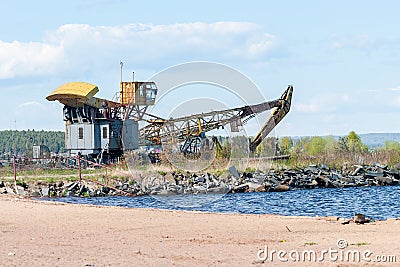 Old port crane on the lake shore Stock Photo