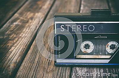 Old portable cassette player on a wooden background. image is instagram style filtered Stock Photo