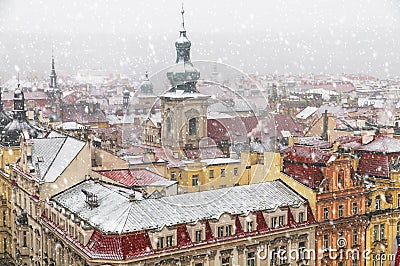 Old Prague architecture and red roofs view from above in winter snowfall Stock Photo