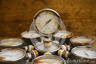 Old pressure gauge or damage pressure gauge of oil and gas industry on wooden background, Equipment of production process Stock Photo