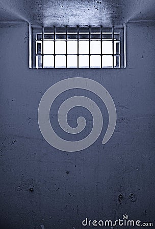 Old prison cell with barred window Stock Photo