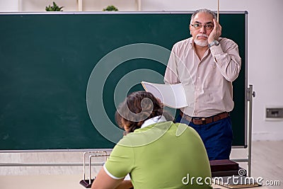 Old professor physicist and young student in the classroom Stock Photo