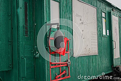 Old railway station and wooden train car. the bell of the old train. ax and shovel Editorial Stock Photo