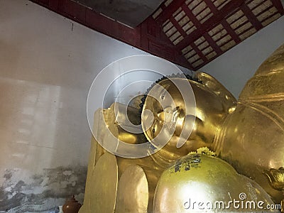 Old Reclining Buddha in the old chapel with gold color Stock Photo