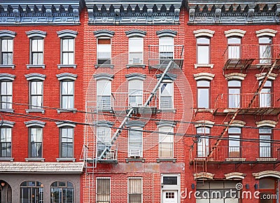 Old red brick buildings with blue iron fire escapes, New York City, USA Stock Photo