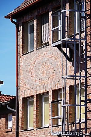 Old red brick factory building under blue sky Stock Photo