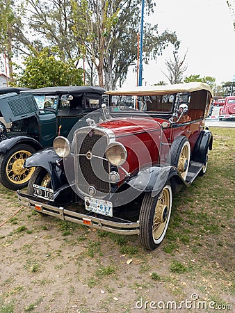 Old red 1931 Chevrolet Chevy Phaeton four door by GM in a park. AAA 2022 classic car show Editorial Stock Photo
