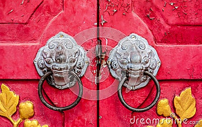 Old red chinese temple door with crave leaf Stock Photo