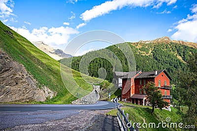 Old red house on Timmeljoch mountain pass on Italian side of Alps on the way to Merano, South Tyrol, Italy. Stock Photo