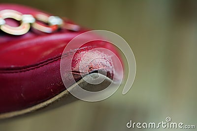 Old red leather woman shoe with worn toe. Blurred selective focus Stock Photo