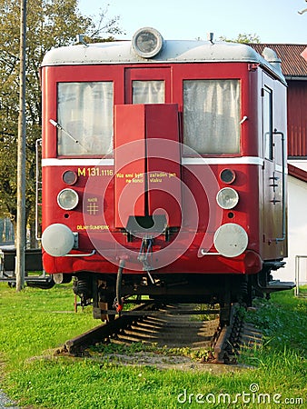 Old red train waggon at piece of rail Stock Photo