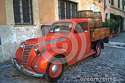 Old red vintage car in the center of Rome, Italy Editorial Stock Photo