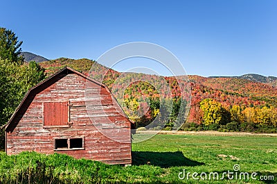 Old Red Wooden Barn in the Adirondacks during the Foliage Peak Stock Photo