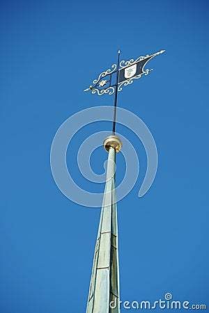 Old reformed church tower in Urdorf, Switzerland detail or close up on the wind pointer or wind pointer decorated with golden smit Stock Photo