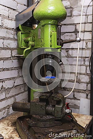 An old reliable drilling machine in the workshop, metalworking, machine tools Stock Photo