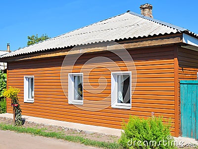 Old renovation house with new plastic siding walls and old asbestos roof. Stock Photo