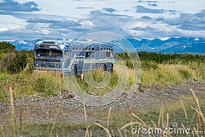 Old retro abandoned bus sits along in a marsh along the Homer Spit in Alaska Stock Photo