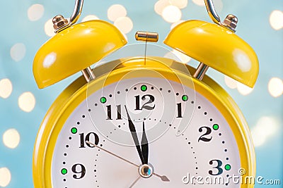 Nostalgic Festive Charm: Retro Alarm Clock and Christmas Lights Stock Photo