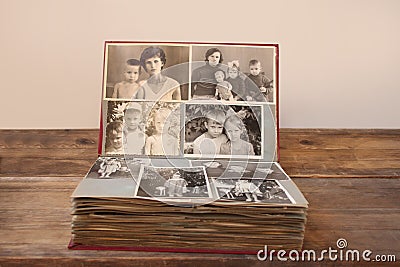 Old retro album with vintage monochrome photographs in sepia color, the concept of genealogy, the memory of ancestors, family ties Stock Photo