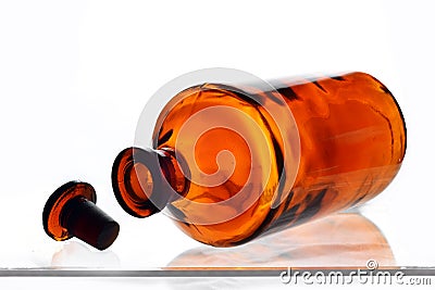 Old retro big bottle brown glass with glass askew plug on a white background Stock Photo