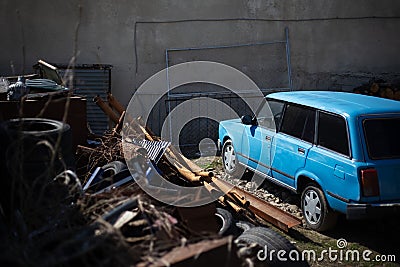 Old retro blue car at the scrap dump Stock Photo