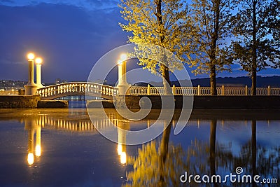 Old retro bridge and reflection over water. Stock Photo