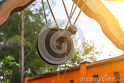 An old retro bronze gong in the form of a circle suspended not on a rope near a bat to signal an attack or event. Concept of old Stock Photo