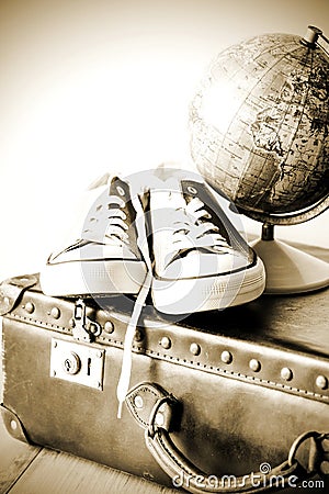 Old retro holiday suitcase and shoes for globetrotter Stock Photo