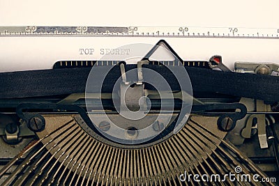 Old retro vintage typewriter. A white sheet with the printed text top secret Stock Photo