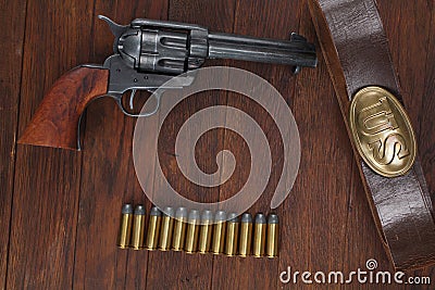 Old revolver with cartridges and U.S. Army soldier& x27;s belt with a buckle Stock Photo