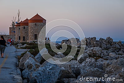 Old Rhodes windmills in Mandraki port Editorial Stock Photo