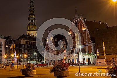 Old Riga the capital of Latvia at night. House of Blackheads in the Town Hall Square and the spire of the Cathedral in the Editorial Stock Photo