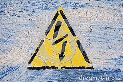 Old risk of electric shock triangle sign on light grey weathered cracked background Stock Photo