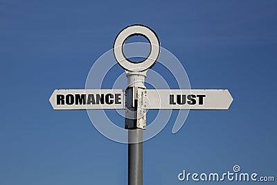 Old road sign with romance and lust pointing in opposite directions Stock Photo