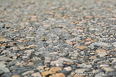 The old road, small stones and asphalt close up with a small depth of field. Stock Photo