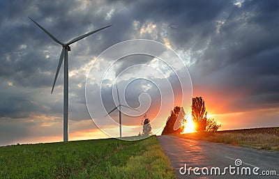Old road and wind power generators at the sunset Stock Photo